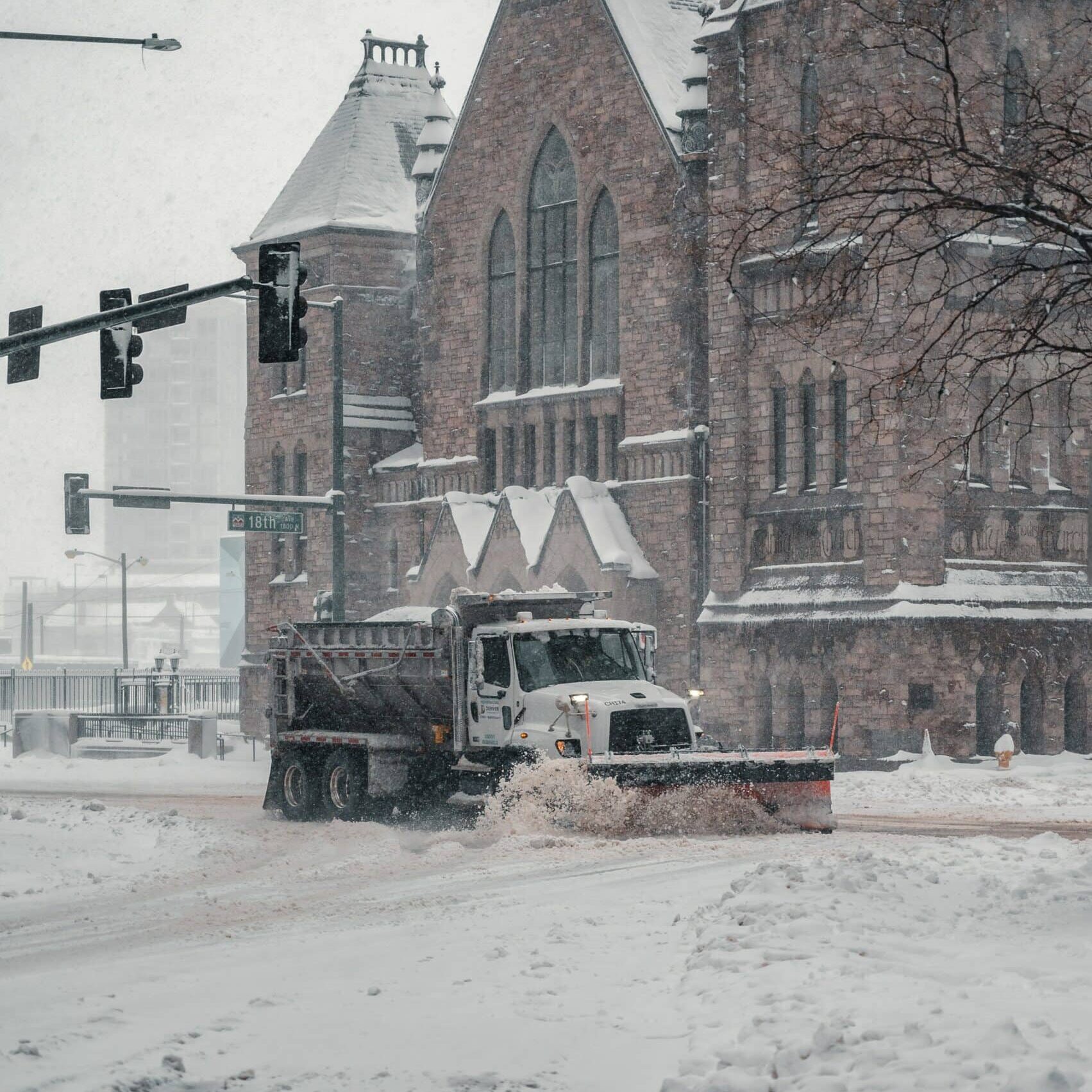 Reliable commercial snow plowing equipment from Arellano Landscaping clearing accumulated snow from business entrances in South Elgin