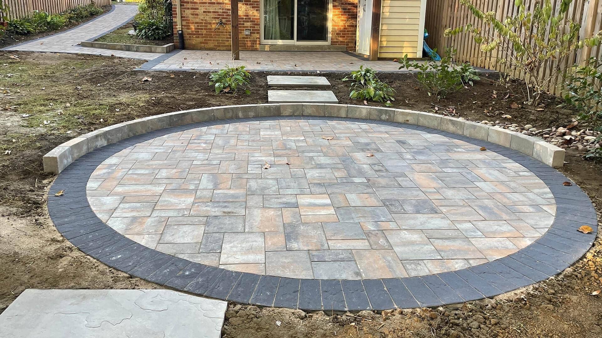 Elegant circular hardscape feature designed and built by Arellano Landscaping in St. Charles, IL, showcasing expert craftsmanship and durable stonework.